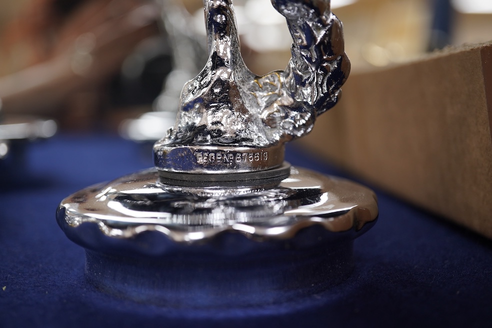 Five chrome car mascots in the form of female dancing figures, three mounted on threaded radiator caps, one with a registration number: 675619, one a stylised Art Deco winged female figure astride a globe. Condition - fa